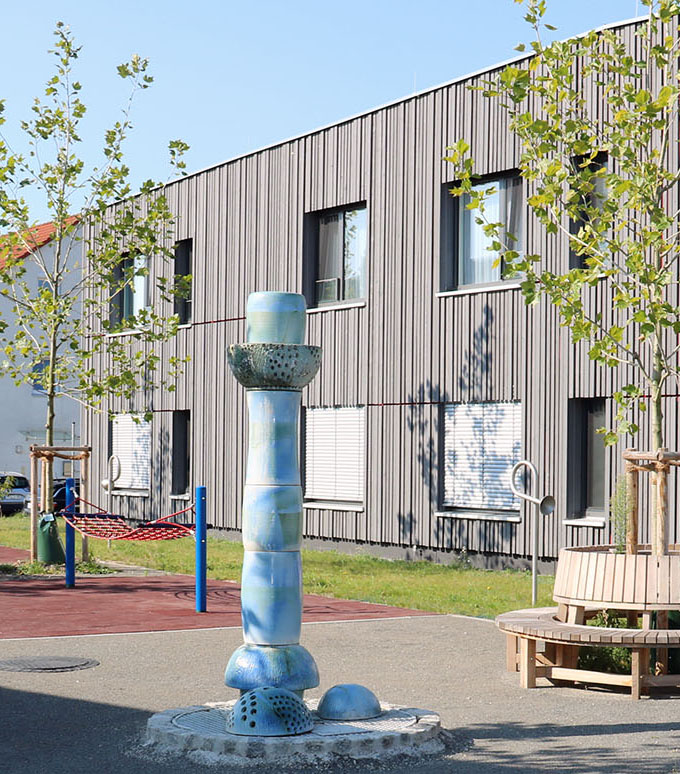 Blick auf den Spielplatz zwischen Cafeteria und Wohnhaus.